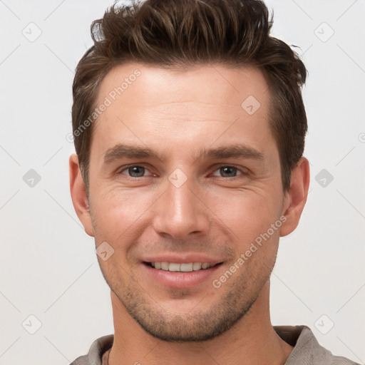 Joyful white young-adult male with short  brown hair and brown eyes