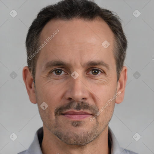 Joyful white adult male with short  brown hair and brown eyes