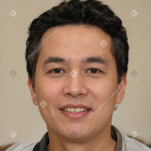 Joyful white adult male with short  black hair and brown eyes