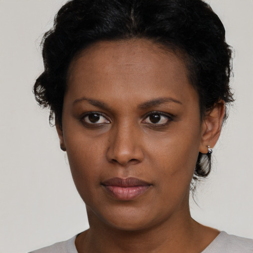 Neutral black young-adult female with short  black hair and brown eyes