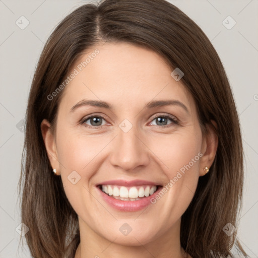 Joyful white young-adult female with medium  brown hair and grey eyes