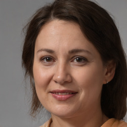 Joyful white adult female with medium  brown hair and brown eyes