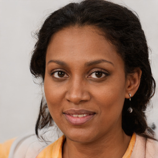 Joyful black young-adult female with medium  brown hair and brown eyes