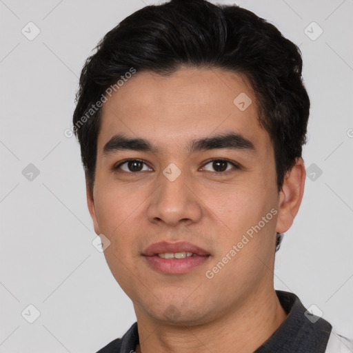 Joyful white young-adult male with short  black hair and brown eyes