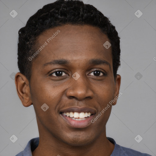 Joyful black young-adult male with short  brown hair and brown eyes