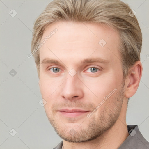 Joyful white adult male with short  brown hair and grey eyes