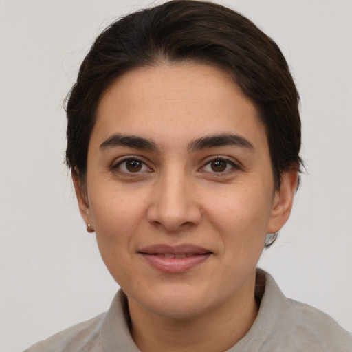 Joyful white young-adult female with short  brown hair and brown eyes