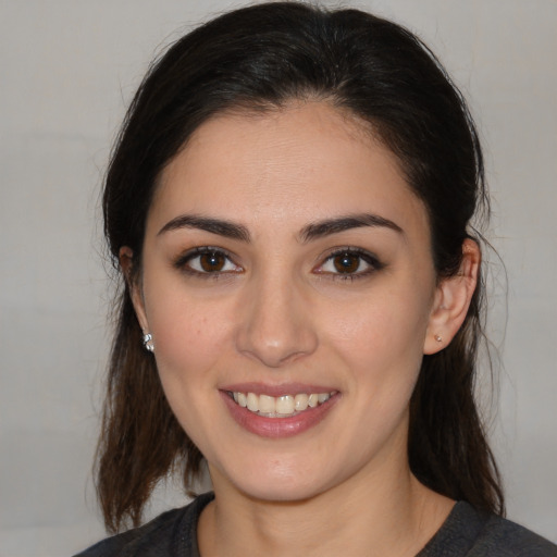 Joyful white young-adult female with medium  brown hair and brown eyes