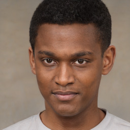 Joyful latino young-adult male with short  brown hair and brown eyes