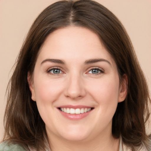 Joyful white young-adult female with medium  brown hair and grey eyes