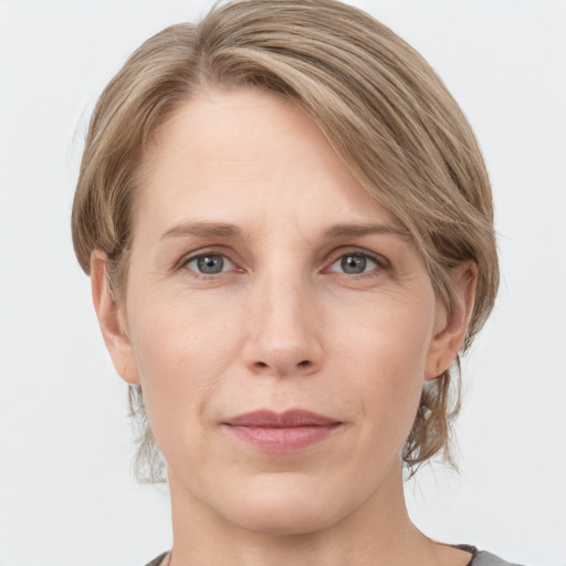 Joyful white adult female with medium  brown hair and grey eyes