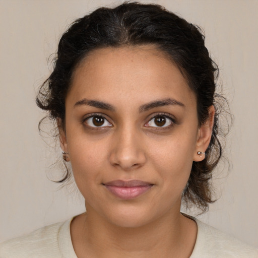 Joyful latino young-adult female with medium  brown hair and brown eyes