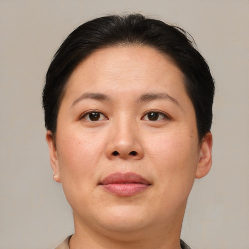 Joyful asian young-adult female with short  brown hair and brown eyes