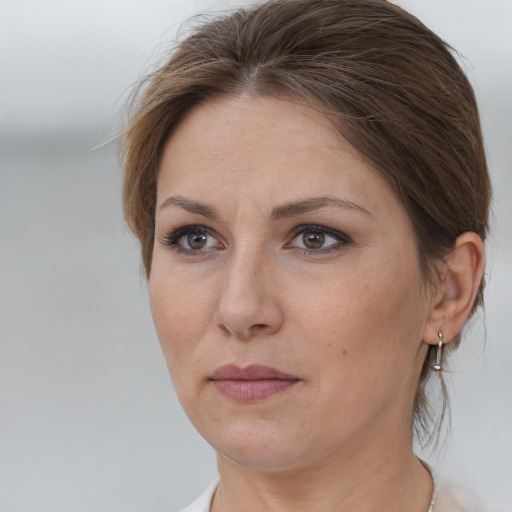 Joyful white adult female with medium  brown hair and brown eyes