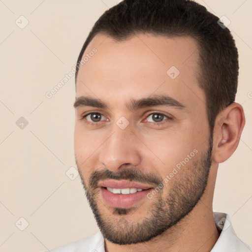 Joyful white young-adult male with short  brown hair and brown eyes