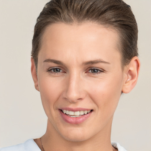 Joyful white young-adult female with short  brown hair and brown eyes