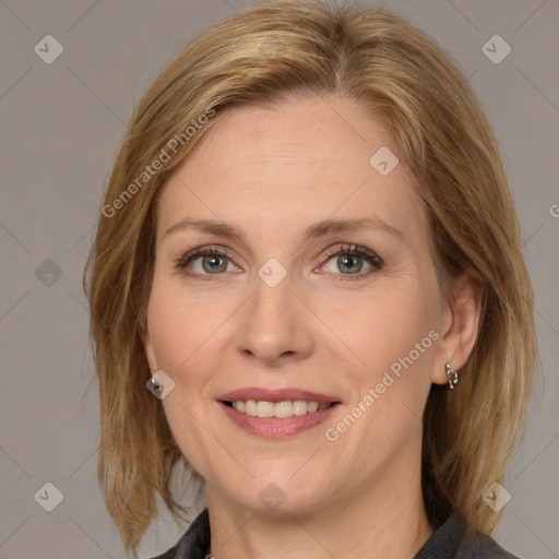 Joyful white adult female with medium  brown hair and grey eyes