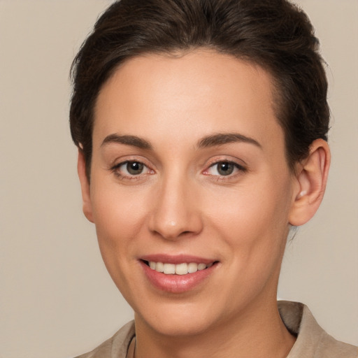 Joyful white young-adult female with short  brown hair and brown eyes