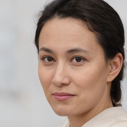 Joyful white adult female with medium  brown hair and brown eyes