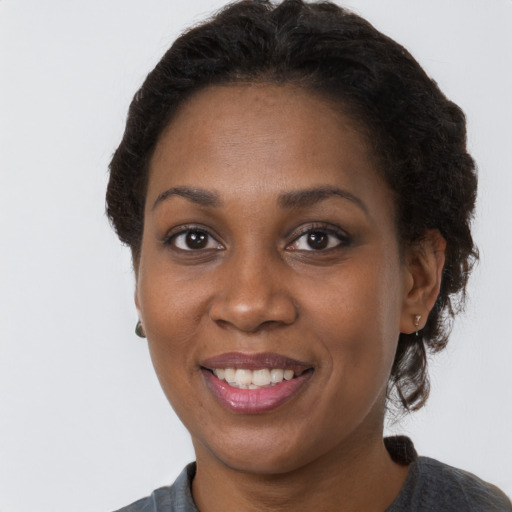 Joyful black young-adult female with short  brown hair and brown eyes
