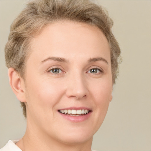 Joyful white young-adult female with short  brown hair and grey eyes