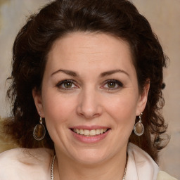 Joyful white young-adult female with medium  brown hair and green eyes