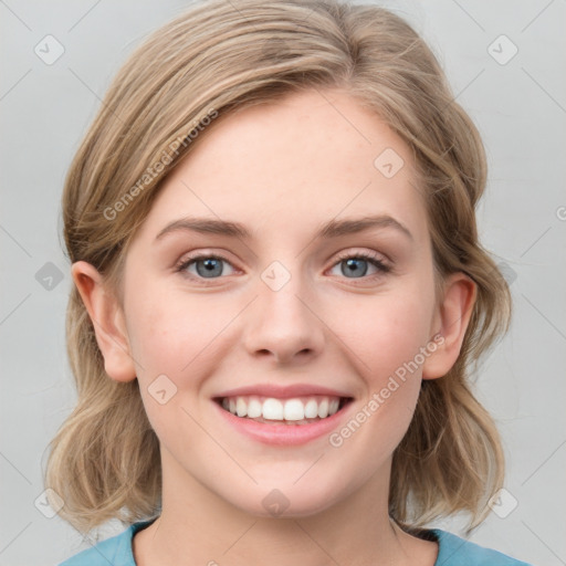 Joyful white young-adult female with medium  brown hair and blue eyes