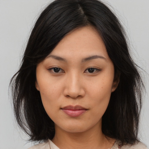 Neutral asian young-adult female with medium  brown hair and brown eyes