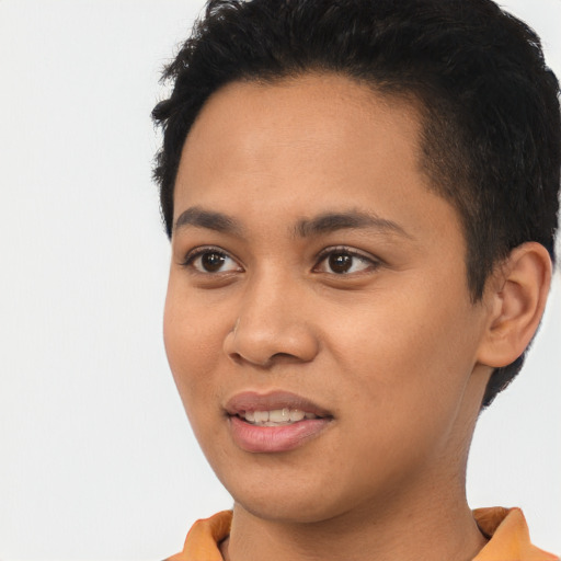 Joyful latino young-adult female with short  black hair and brown eyes