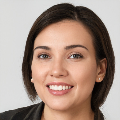 Joyful white young-adult female with long  brown hair and brown eyes