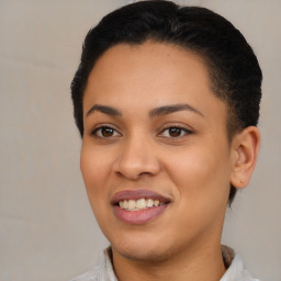 Joyful latino young-adult female with short  brown hair and brown eyes