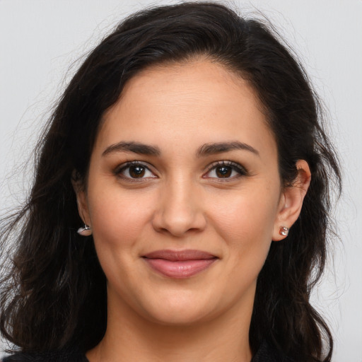 Joyful latino young-adult female with long  brown hair and brown eyes