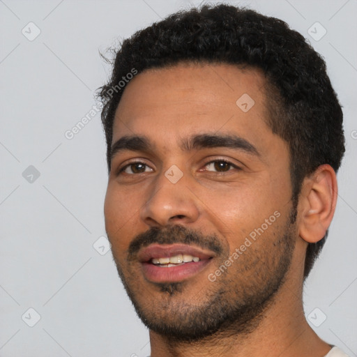 Joyful black young-adult male with short  black hair and brown eyes