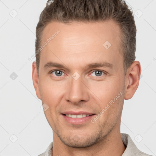 Joyful white adult male with short  brown hair and brown eyes