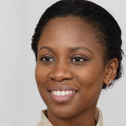 Joyful black young-adult female with medium  brown hair and brown eyes