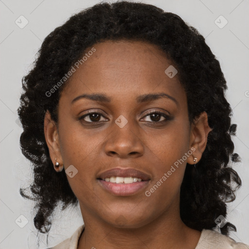 Joyful black young-adult female with medium  brown hair and brown eyes