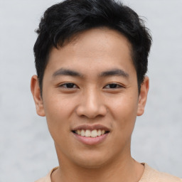 Joyful asian young-adult male with short  black hair and brown eyes