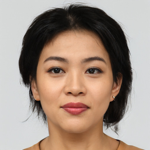 Joyful asian young-adult female with medium  black hair and brown eyes