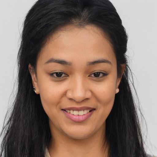 Joyful asian young-adult female with long  brown hair and brown eyes