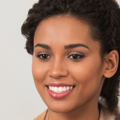 Joyful latino young-adult female with long  brown hair and brown eyes