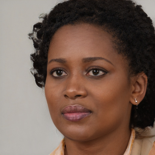 Neutral black young-adult female with long  brown hair and brown eyes