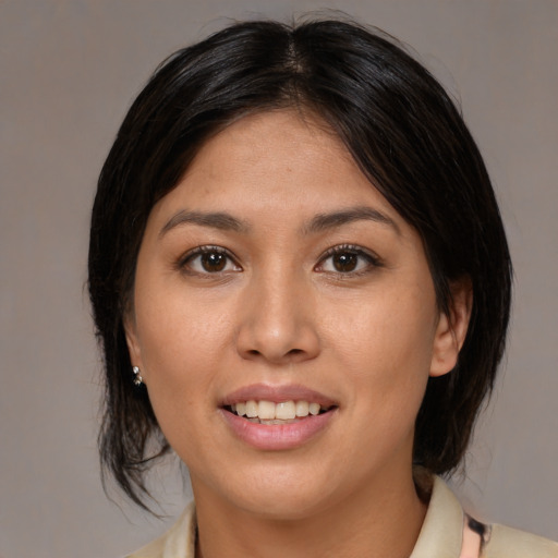 Joyful latino young-adult female with medium  brown hair and brown eyes