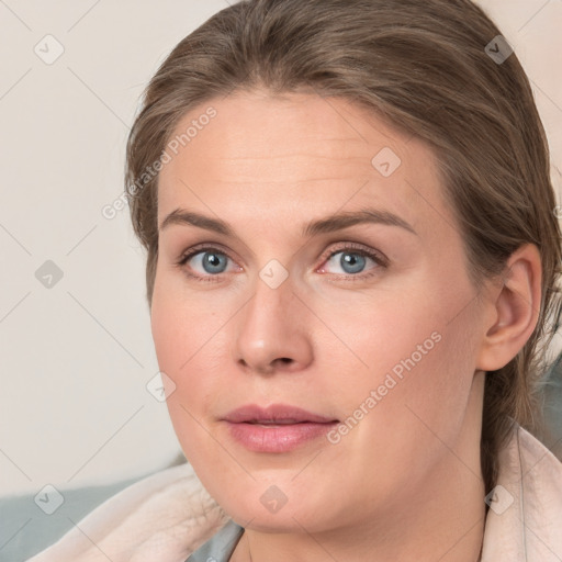 Joyful white young-adult female with medium  brown hair and blue eyes