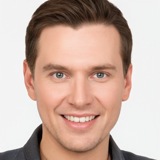 Joyful white young-adult male with short  brown hair and grey eyes