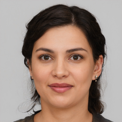 Joyful latino young-adult female with medium  brown hair and brown eyes