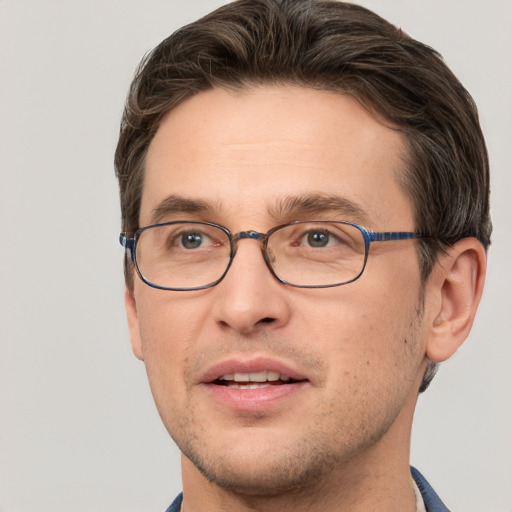 Joyful white adult male with short  brown hair and grey eyes