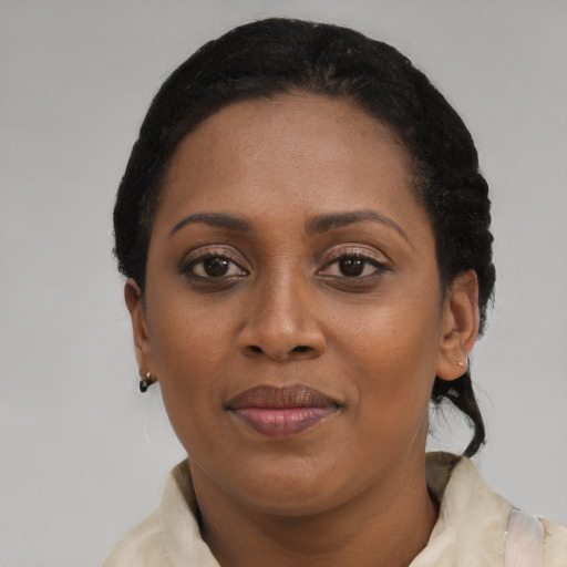 Joyful black young-adult female with short  brown hair and brown eyes
