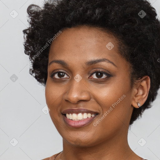 Joyful black young-adult female with short  black hair and brown eyes