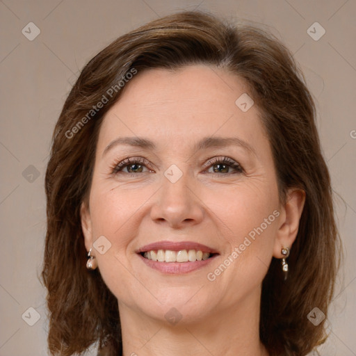 Joyful white adult female with medium  brown hair and brown eyes