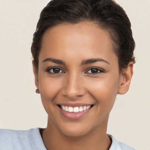 Joyful white young-adult female with short  brown hair and brown eyes